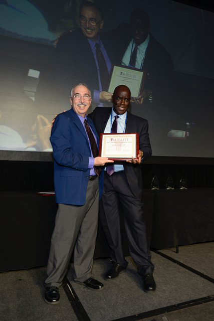 Moustapha Diack recieves an award from Gerry Hanley